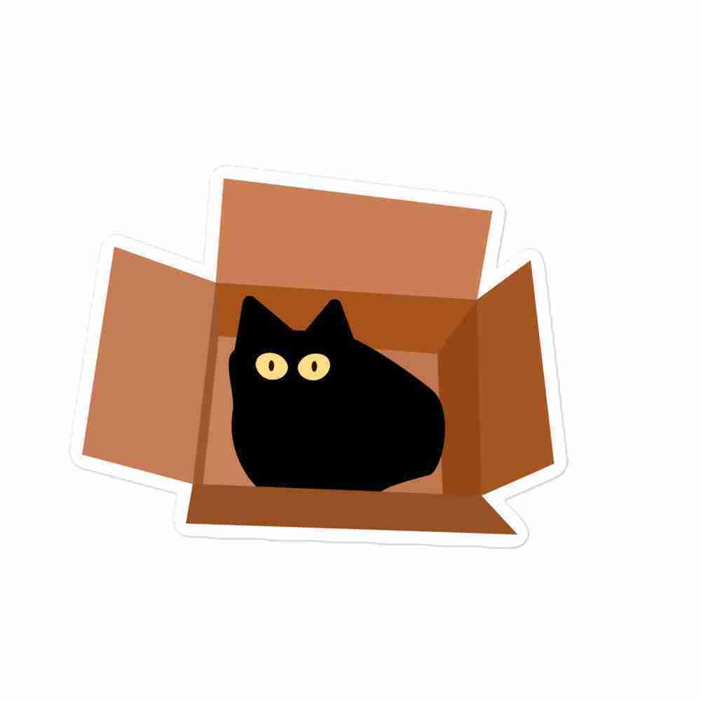 A sticker of a black cat-shaped blob with pale yellow eyes looking up out of a cardboard box.
