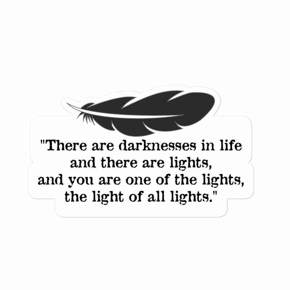 A sticker of a black feather, with text underneath reading "There are darknesses in life and there are lights, and you are one of the lights, the light of all lights."