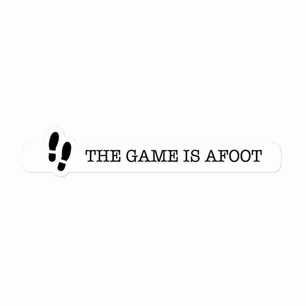 A sticker of a pair of footsteps with text to the right reading "The game is afoot".