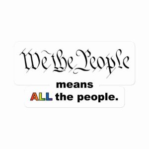 A sticker of text reading "We the People" in an 18th century calligraphy font and more text underneath reading "means ALL the people", with "all" being in a rainbow gradient.