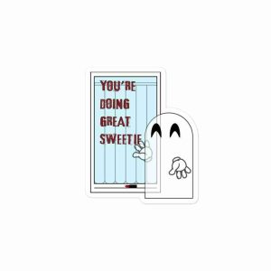 A sticker of a ghost smiling at a bathroom mirror where they have just written "you're doing great, sweetie" in red lipstick. The lipstick tube sits on a shelf at the base of the mirror, and a blue shower curtain is reflected in the surface.